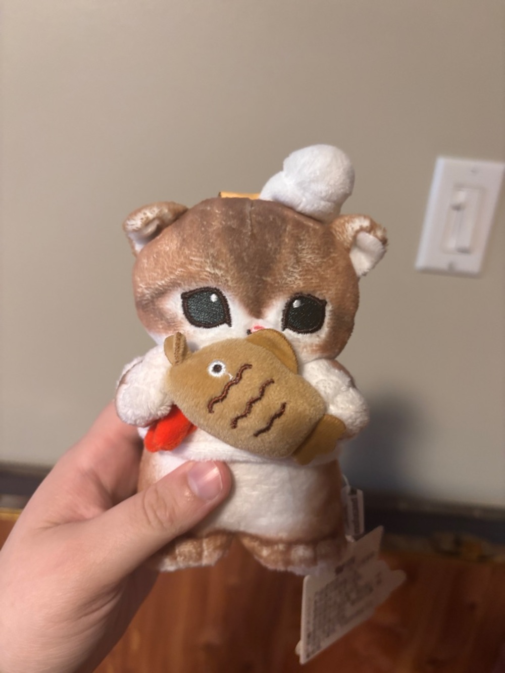 Brown and Cream Plush Cat Holding Fish Toy